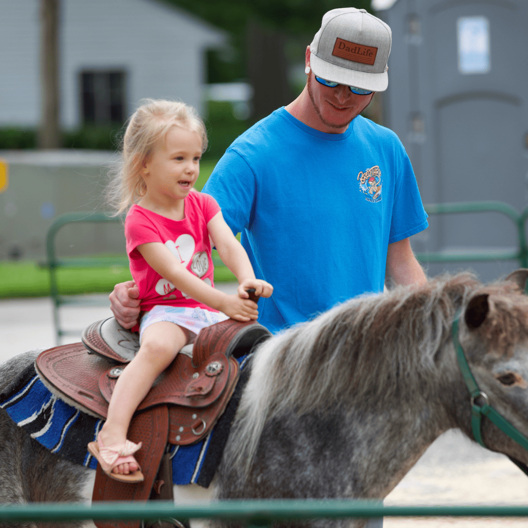 young girl riding a pony at the Ashland Strawberry Faire