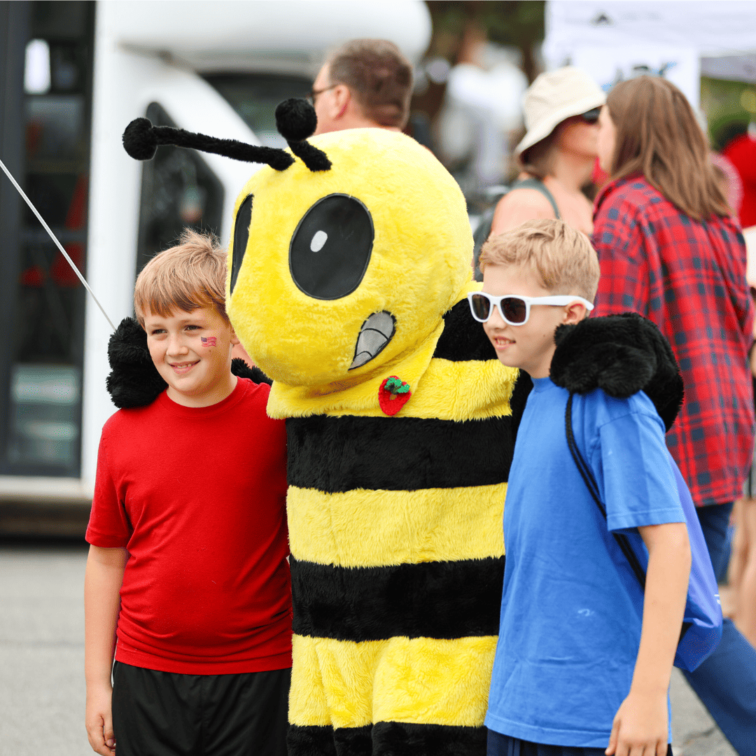 two boys with a yellow jacket mascot