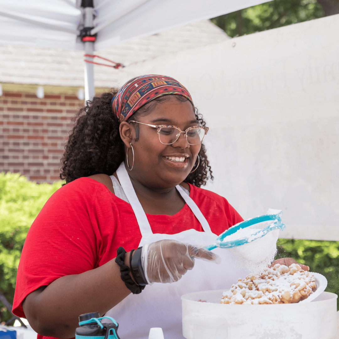 Woman making funnel cakes at the Ashland Strawberry Faire