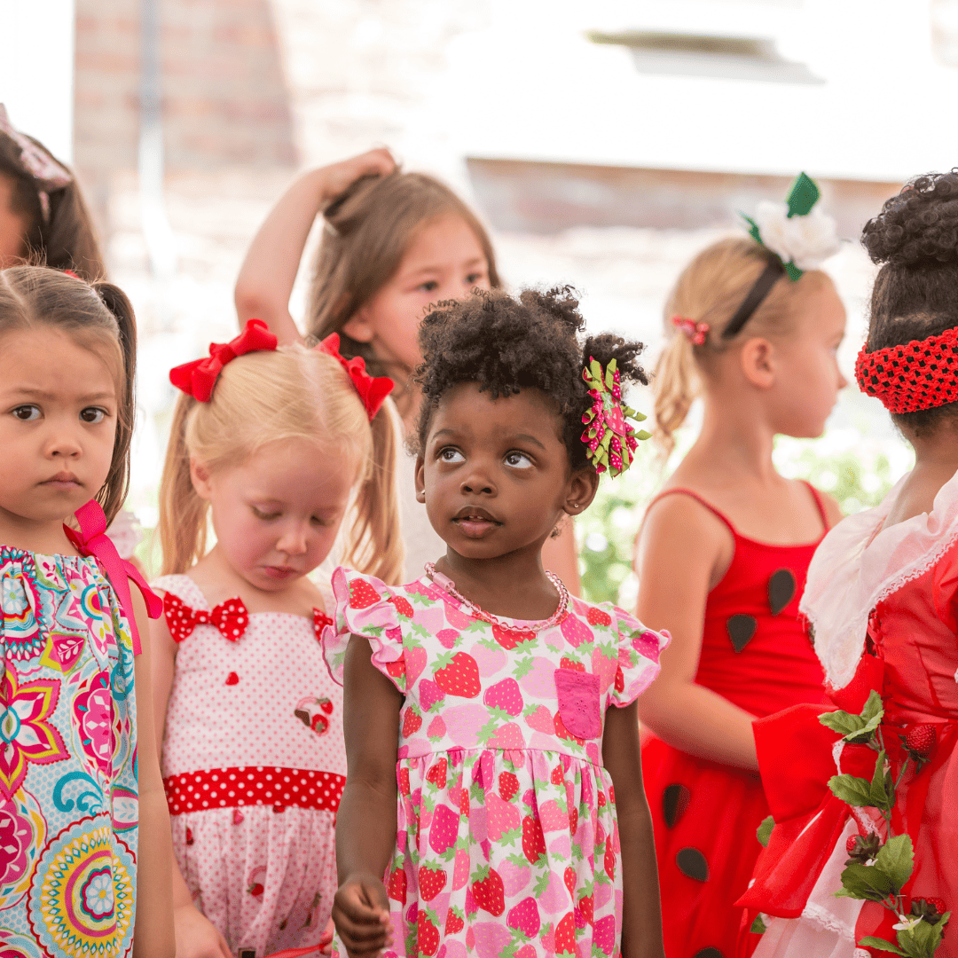 little girls wearing strawberry dresses at the Ashland Strawberry Faire
