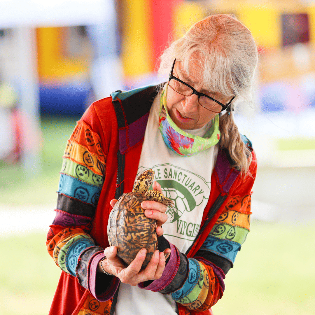 woman holding a turtle at the BARKing Lot