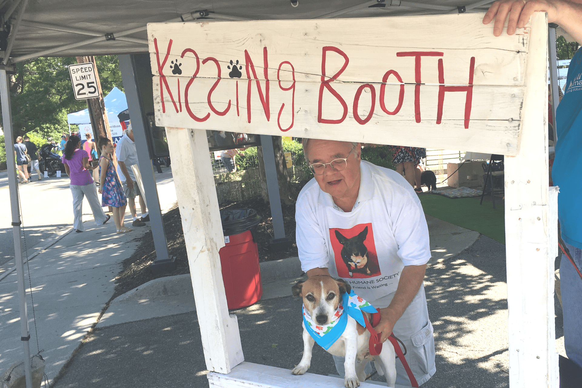 dog and man at the kissing booth