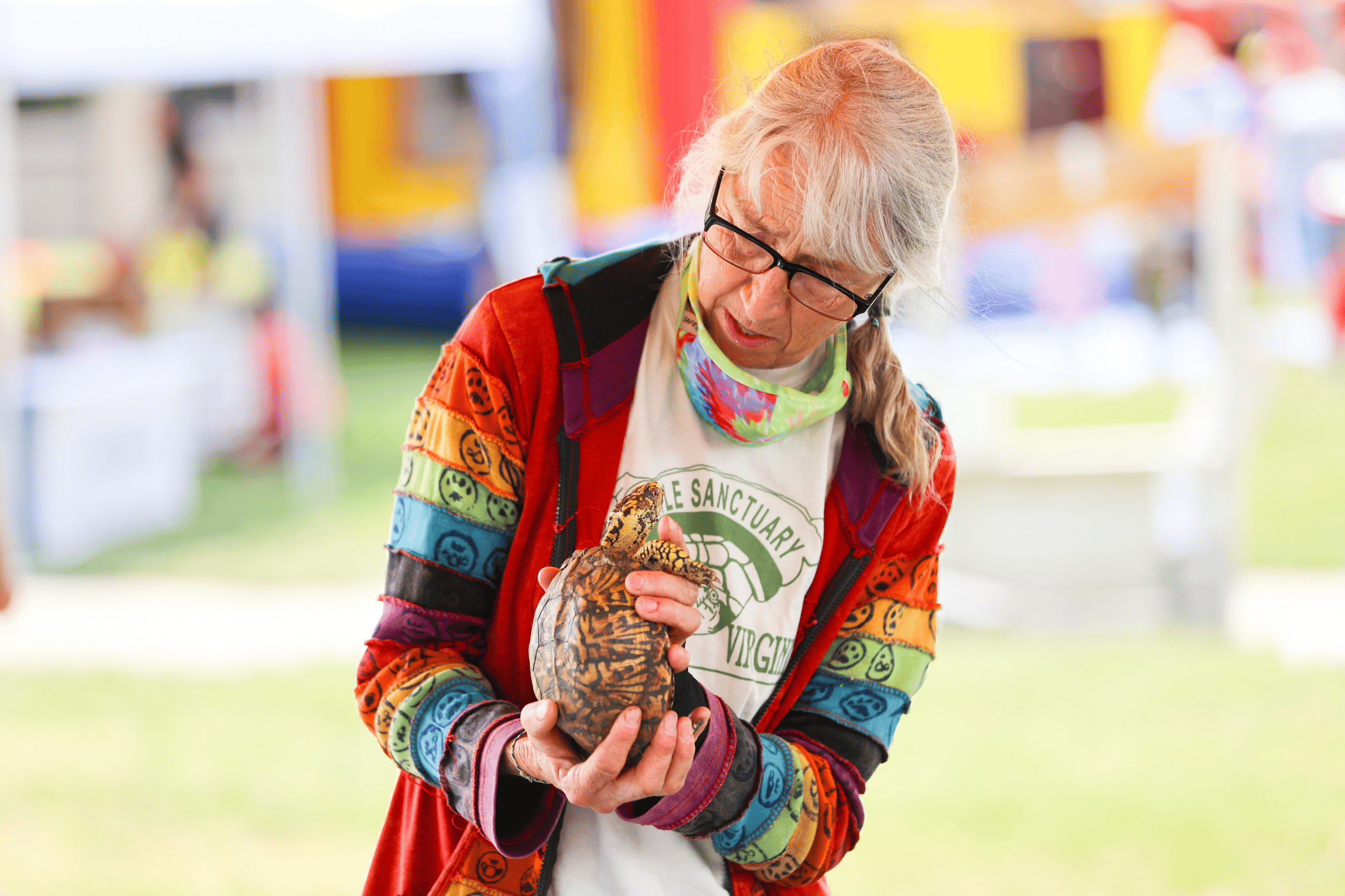 older woman holding a box turtle
